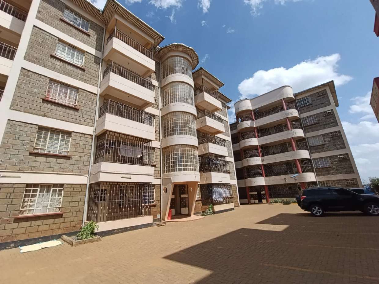 Apartment block exterior with paved parking at Pioneer, Eldoret